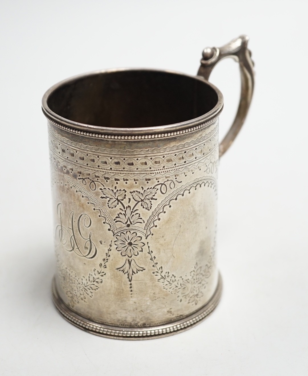 A Victorian engraved silver christening mug, Charles Stuart Harris, London, 1881, height 92mm, with engraved monogram.